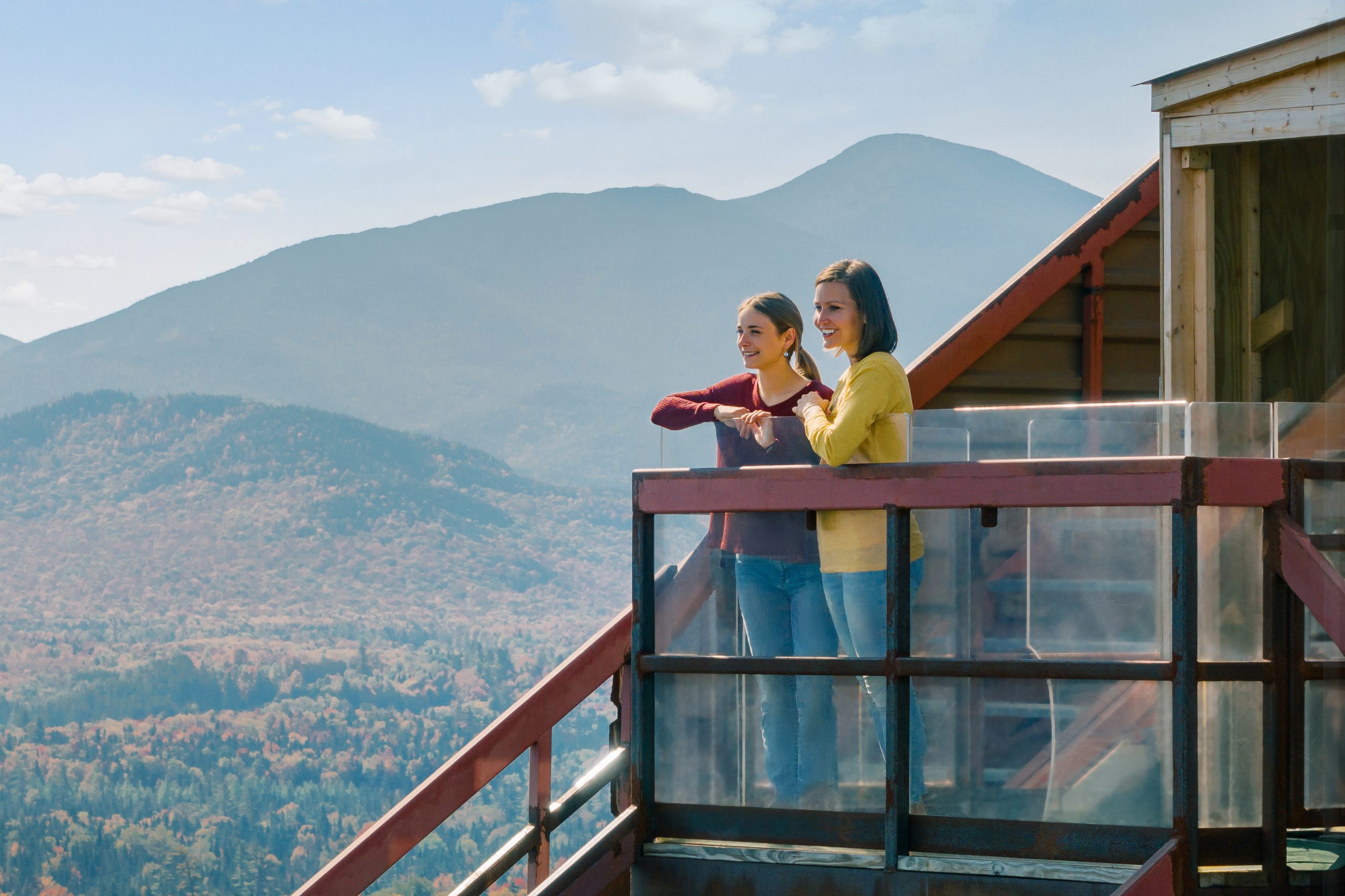 Drone shot showing two women enjoy the view from the top of the observation deck on a fall day.