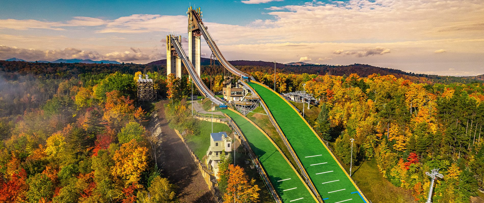 Scenic view of the Olympic Jumping Complex ski jumps during peak foliage.