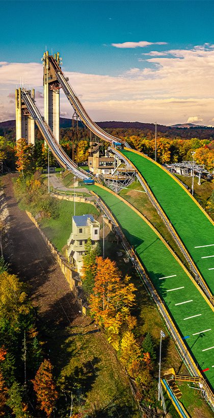 Scenic view of the Olympic Jumping Complex ski jumps during peak foliage.
